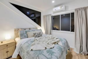 a bedroom with a bed and a window at Brand New Gold Coast Luxury Retreat in Mudgeeraba