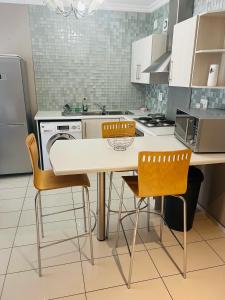 a kitchen with a white table and two chairs at Villa Kristine 3 in Windhoek