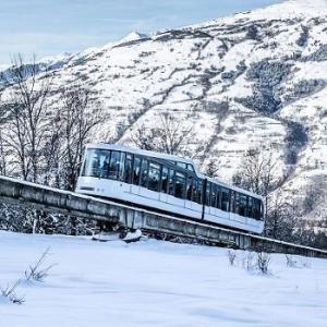 a train on a track with a snow covered mountain at Résidence Deux Tetes - Très agréable 2 pièces dans un quartier calme à 50 mètres des pistes MAE-4491 in Arc 1600 +6 photos