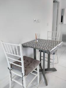 a table and a chair and a table and a table and chairs at Résidence des canaris in Toulouse +3 photos