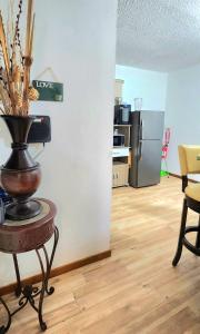 a living room with a table with a vase on it at Sierra Bayamón in Bayamon +5 photos
