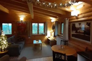 a living room with a couch and a table at Orchid lodge in Bridge of Tilt