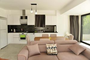 a living room and kitchen with a couch and a table at Villa Sarisli 2 in Ortaca