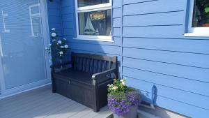 a bench sitting on the front porch of a house at The Beach House in Valley