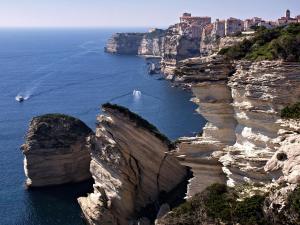 a view of the amalfi coast with a boat in the water at mini villa duplex Bonifacio 70m2 in Bonifacio