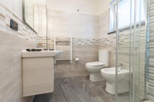 a bathroom with a toilet and a sink and a shower at Light stadium in Taormina +80 photos