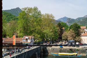 a group of people walking on a bridge over a river at Hotel De‘Andros Virpazar in Virpazar