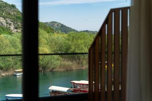 a view from a window of a river with boats at Hotel De‘Andros Virpazar in Virpazar