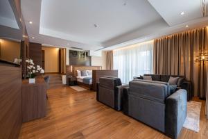 a living room with a couch and a bed at Hotel De‘Andros Virpazar in Virpazar