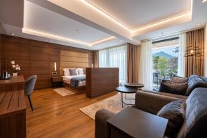 a living room with a couch and a bed at Hotel De‘Andros Virpazar in Virpazar