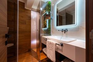 a bathroom with a sink and a mirror at Hotel De‘Andros Virpazar in Virpazar