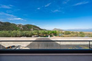 a view from a window of a bridge with a mountain at Hotel De‘Andros Virpazar in Virpazar