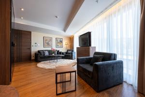 a living room with two couches and a television at Hotel De‘Andros Virpazar in Virpazar