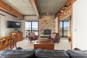 a living room with a couch and a fireplace at Storm Meadows Club A-219, Corner Unit, Amazing Panoramic Views, Ski In Ski Out, Club Amenities in Steamboat Springs