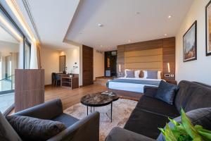 a hotel room with a bed and a couch at Hotel De‘Andros Virpazar in Virpazar