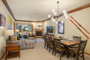 a living room with a table and a couch at Snow Flower 204 -REDUCED RATES- Pool, Hot Tub, Balcony with Views, Steps to Gondolas, Restaurants in Steamboat Springs