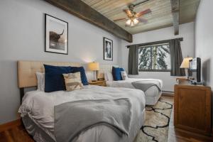 a bedroom with two beds and a television in it at Heated Pool, Private Washer & Dryer, Ski In, Ski Out, Just Remodeled in Steamboat Springs +41 photos