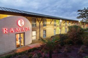 a building with a romada sign in front of it at Ramada Oxford in Waterstock