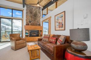 a living room with a leather couch and a table at Heated Pool and Hot Tub, Ski In, Ski Out, Top Level Unit, -Remodeled Fall 2022- in Steamboat Springs +39 photos