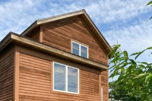 a house with two windows on top of it at Coastal Cove Cottage in Ocean Bay Park +6 photos