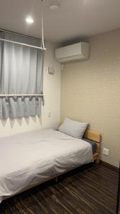Postel nebo postele na pokoji v ubytování 民泊TOKYO one シェアハウス