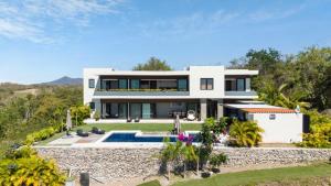 a large white house with a swimming pool at Near Punta Mita - Gorgeous Modern Villa in Higuera Blanca
