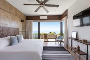 a bedroom with a large bed and a large window at Near Punta Mita - Gorgeous Modern Villa in Higuera Blanca +76 photos