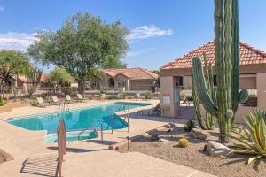 a swimming pool at a resort with a cactus at Serenity Ridge in Scottsdale