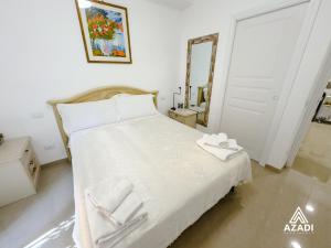 a bedroom with a bed with towels on it at Azadi B&B Flaminio in Rome