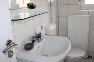 une salle de bain avec un lavabo blanc et des toilettes dans l'établissement Ruhiges & schickes 4 Zi-Apartment, à Heilbronn 31 autres photos