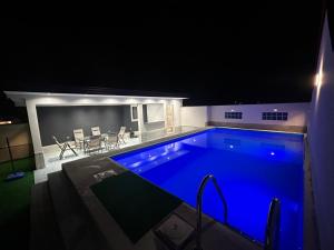 a swimming pool at night with blue lighting at Villa Mešić in Stojčevac +31 photos
