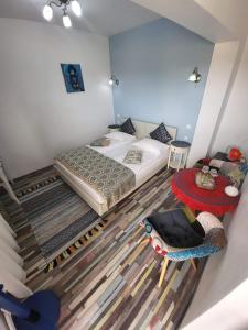 a bedroom with a bed and a table and a chair at Amaraz Center in Sibiu