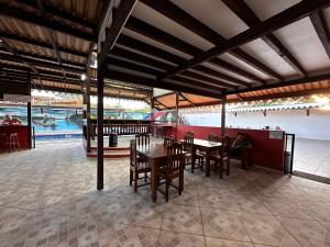 a dining area with tables and chairs and a playground at Hotel La Villa Morena in Oiapoque