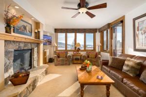 a living room with a couch and a fireplace at Pool and Hot Tubs, Private Washer & Dryer, Creekside Base Area Location in Steamboat Springs