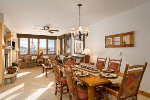 a living room with a dining room table and chairs at Pool and Hot Tubs, Private Washer & Dryer, Creekside Base Area Location in Steamboat Springs