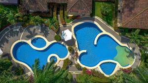 an overhead view of a swimming pool at a resort at Villa Felicidad By Vacation Pura Vida in Esterillos