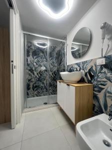 a bathroom with a sink and a shower at Casa mia MadamA in Gaeta +6 photos