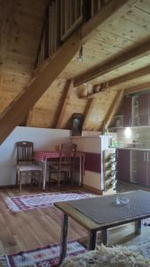 a kitchen with a table and chairs in a room at Vikendica Gradačka Poljana in Šavnik
