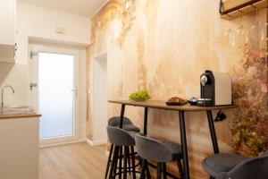 a kitchen with a table and stools in a room at Tosco Suite "Solis" in Sasso dʼOmbrone