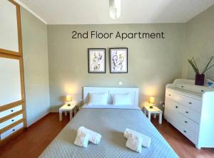 a bedroom with a bed and floor appointment on the wall at Aggelou Apartments-10 mins from Athens airport in Spata