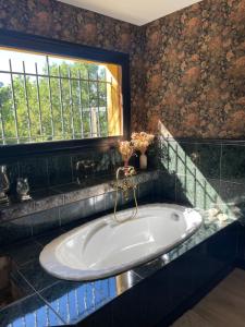 a bath tub in a bathroom with a window at Villa vue panoramique, 6 chambres, piscine chauffée in Espalion +22 photos