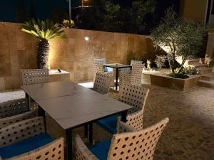a table and chairs in a patio at night at Aquamarine Jaz Montenegro in Budva