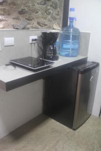 a kitchen counter with a bottle of water on it at Villa Salvador - New Private Suite & Kitchen walk to Playa Chiquita in Talamanca