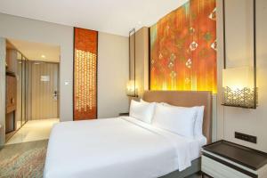 Ένα ή περισσότερα κρεβάτια σε δωμάτιο στο Radisson Lampung Kedaton