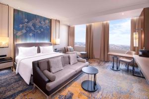 Ένα ή περισσότερα κρεβάτια σε δωμάτιο στο Radisson Lampung Kedaton