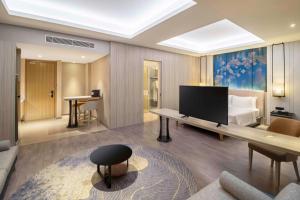 Ένα ή περισσότερα κρεβάτια σε δωμάτιο στο Radisson Lampung Kedaton