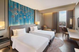 Ένα ή περισσότερα κρεβάτια σε δωμάτιο στο Radisson Lampung Kedaton