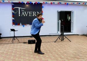 a man is standing in front of a building at Towervans Holiday Park in Mablethorpe