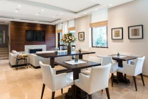 a dining room with a table and chairs and a fireplace at Ayia Marina Suites in Ouranoupoli