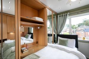 a bedroom with two beds and a large window at Wickersley House, Rotherham for contractors & Families, free parkin, wifi etc in Wickersley